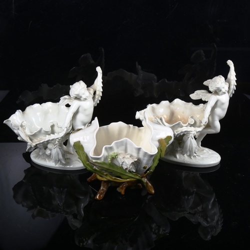 881 - A pair of white glaze porcelain cherub table centre bowls, and another similar leaf bowl (3)