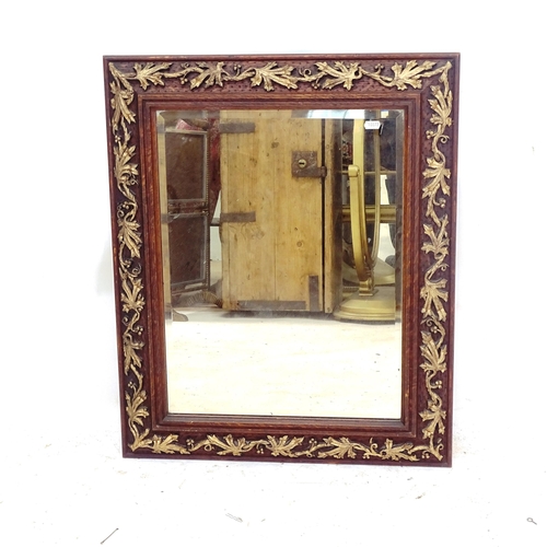 2158 - An oak-framed bevel-edge wall mirror, with applied gilded decoration, 62cm x 73cm