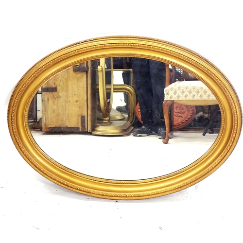 2160 - An oval giltwood wall mirror, W65cm, L90cm