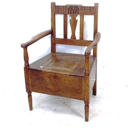 2255 - A Victorian Arts and Crafts oak commode chair, with inscription JJH 1870