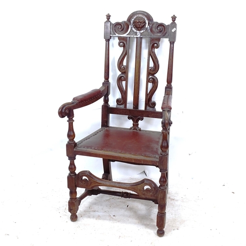 2261 - A 19th century oak Baronial type hall chair, with carved lion mask back, and turned stretchers