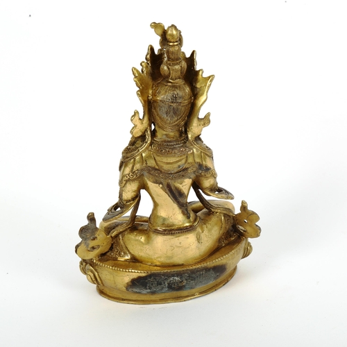 87 - A polished bronze stone set seated Buddha, on lotus base, height 22cm