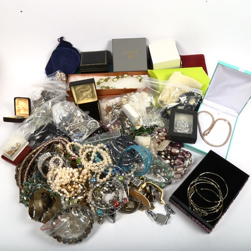 1038 - A large quantity of mixed costume jewellery, brooches, bead necklaces, filigree brooches, wristwatch... 