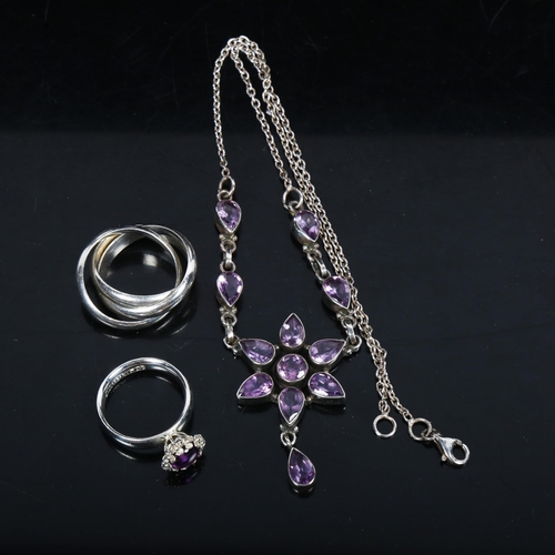 1064 - A silver and amethyst set star design drop pendant necklace, with matching ring, and a silver puzzle... 