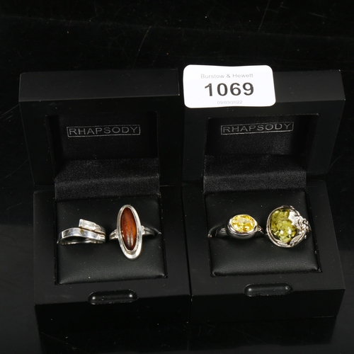 1069 - 4 silver stone and amber set dress rings