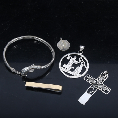 1075 - A sterling silver dolphin design bangle, crucifix pendants etc