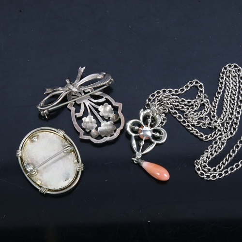 1082 - 3 Continental silver necklaces, to include a coral set drop pendant, a flower and ribbon drop pendan... 