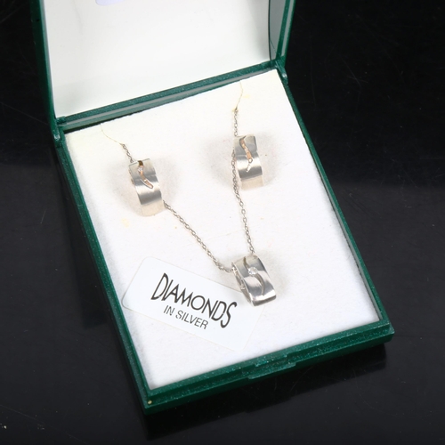 1083 - A silver and diamond set pendant necklace and pair of matching earrings