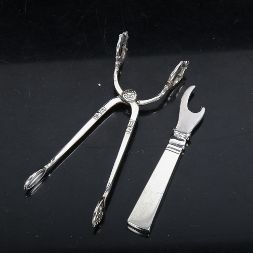 1098 - GEORG JENSEN - a silver bottle opener (boxed), and COHR - a pair of stylised silver tongs