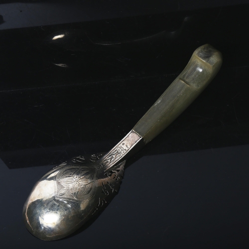 1142 - An Indian engraved and pierced white metal and horn-handled serving spoon