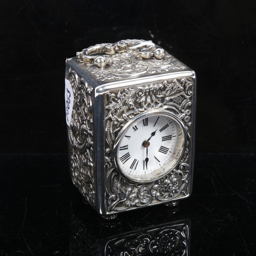 1148 - An Elizabeth II embossed silver-cased carriage clock, white enamel dial and Roman numerals, London 1... 