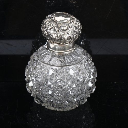 1150 - A cut-glass and silver-mounted scent bottle