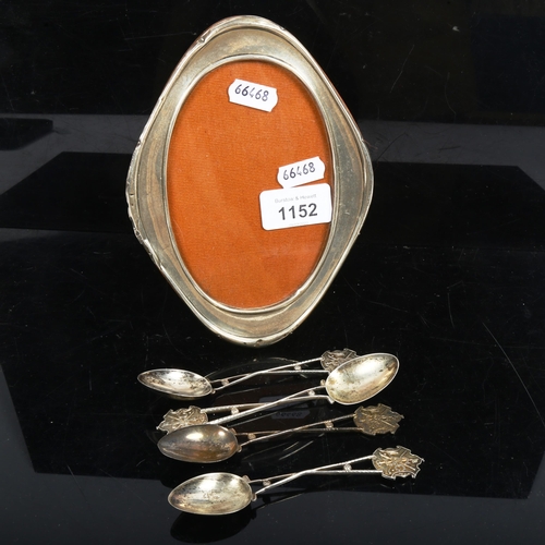 1152 - An oval silver-fronted photo frame, and a set of 4 silver golfing presentation spoons