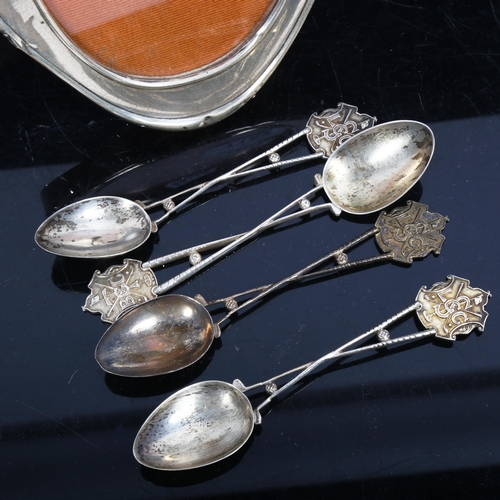 1152 - An oval silver-fronted photo frame, and a set of 4 silver golfing presentation spoons