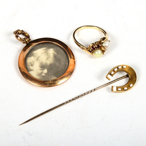 1168 - A gold pearl interwoven and red stone set ring, a 15ct horseshoe design stick pin, and a photo penda... 