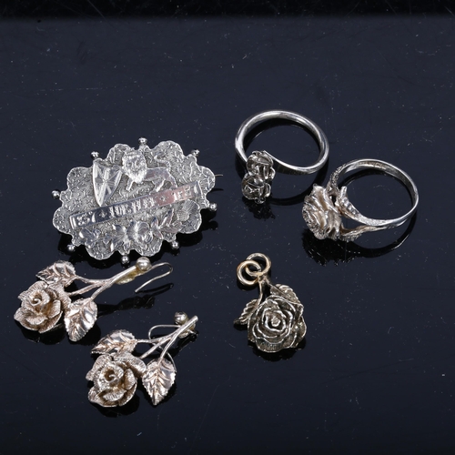 1172 - A Victorian embossed and engraved Jubilee brooch 1837 - 1887, and a group of silver flowerhead desig... 