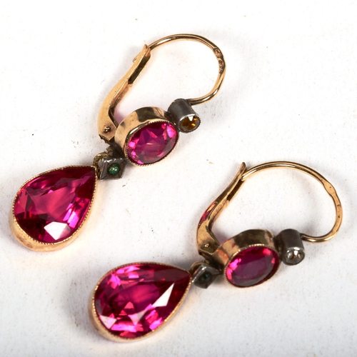 1183 - A pair of 14ct gold and red stone set tear-drop design earrings, 3.8g