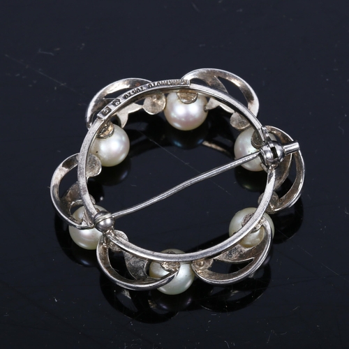 1188 - K MIKIMOTO TOKYO - an interwoven circular marcasite and pearl set brooch, stamped to the back