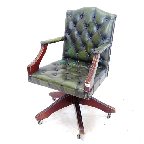 2332 - An early 20th century green leather upholstered swivel desk chair