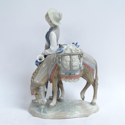 811 - A Lladro porcelain figural group, man with donkey, height 27cm