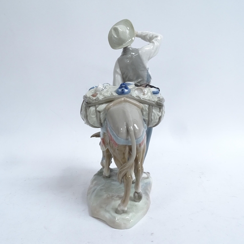 811 - A Lladro porcelain figural group, man with donkey, height 27cm