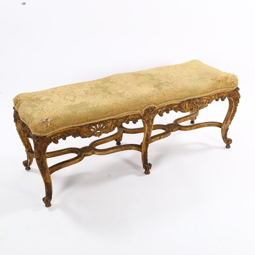 1398 - An ornate 19th century carved giltwood duet stool, raised on 6 cabriole legs with cross stretchers, ... 