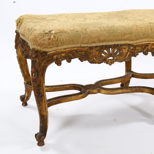 1398 - An ornate 19th century carved giltwood duet stool, raised on 6 cabriole legs with cross stretchers, ... 