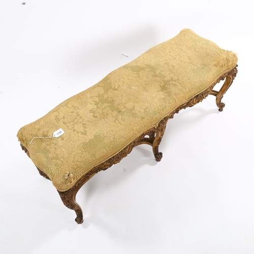 1398 - An ornate 19th century carved giltwood duet stool, raised on 6 cabriole legs with cross stretchers, ... 