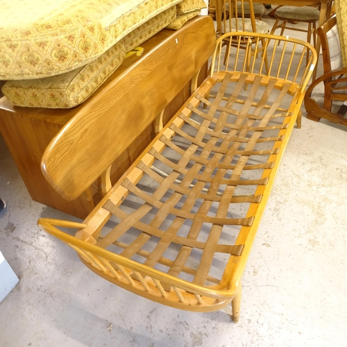 2674 - A mid-century Ercol elm and beech day bed/settee, L200cm, together with a matching footstool