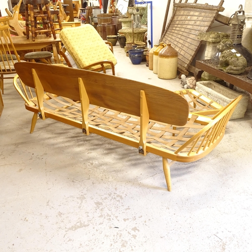 2674 - A mid-century Ercol elm and beech day bed/settee, L200cm, together with a matching footstool