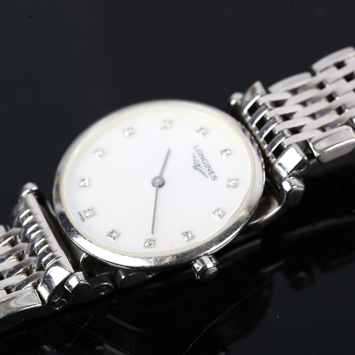 64 - LONGINES - a lady's stainless steel La Grande Classique quartz bracelet watch, ref. L4.209.4, mother... 