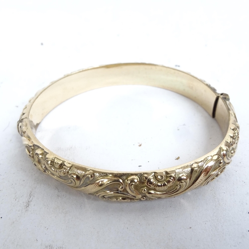 1103 - An embossed gold plated bangle and other gilded jewellery