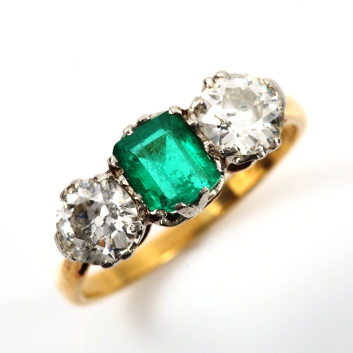 142 - An 18ct gold three stone emerald and diamond ring, platinum topped with emerald-cut emerald and old ... 