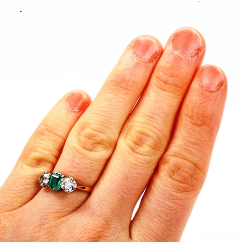 142 - An 18ct gold three stone emerald and diamond ring, platinum topped with emerald-cut emerald and old ... 