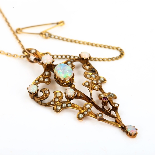 145 - An Edwardian 9ct gold opal ruby and pearl pendant necklace, openwork foliate design set with cabocho... 