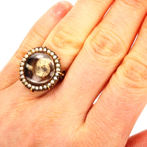 156 - A large 19th century pearl cluster mourning ring, central hair panel beneath convex crystal with bor... 