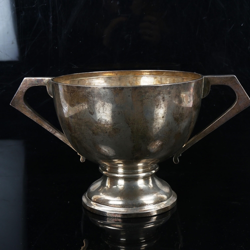 161 - A large Edwardian silver 2-handled trophy, circular form with angular handles and pedestal base, by ... 