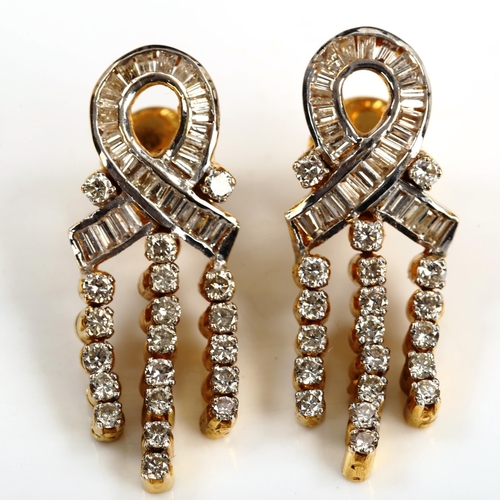 165 - A pair of diamond ribbon earrings, unmarked gold settings, set with baguette and modern round brilli... 