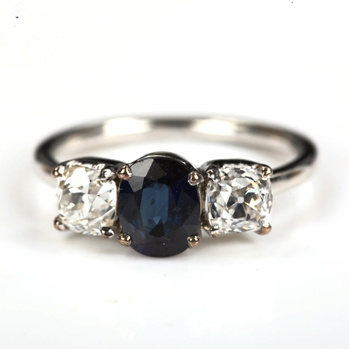 168 - A three stone sapphire and diamond ring, unmarked white metal settings with oval mixed-cut sapphire ... 