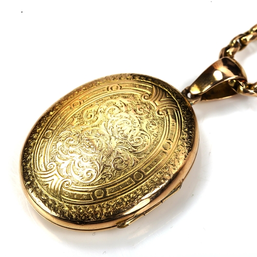 169 - A Victorian unmarked gold locket pendant necklace, allover engraved foliate decoration, on 9ct facet... 