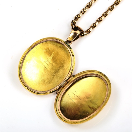 169 - A Victorian unmarked gold locket pendant necklace, allover engraved foliate decoration, on 9ct facet... 