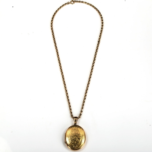 169 - A Victorian unmarked gold locket pendant necklace, allover engraved foliate decoration, on 9ct facet... 