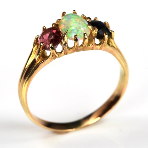 172 - An three stone opal sapphire and garnet half hoop ring, unmarked gold settings with oval cabochon op... 