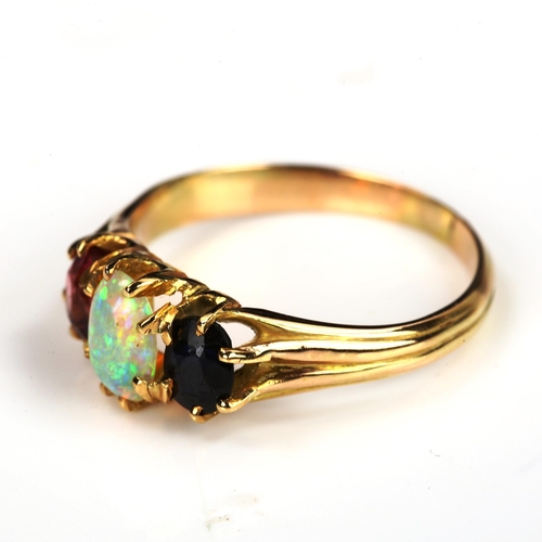 172 - An three stone opal sapphire and garnet half hoop ring, unmarked gold settings with oval cabochon op... 