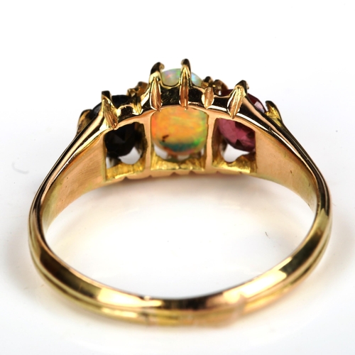 172 - An three stone opal sapphire and garnet half hoop ring, unmarked gold settings with oval cabochon op... 