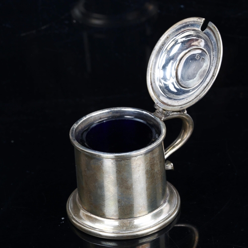 183 - A George V silver lidded tankard design mustard pot, with blue glass liner, by A Marston & Co, hallm... 