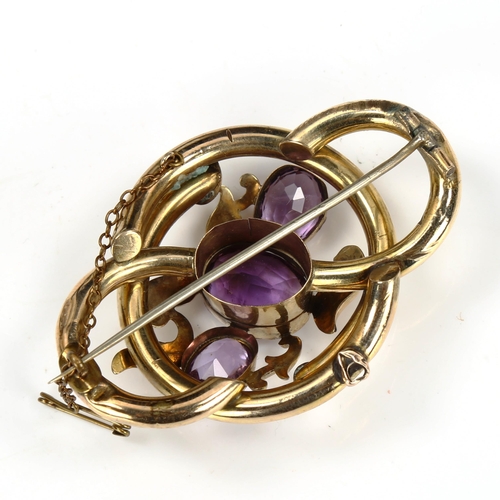 201 - A large Victorian amethyst knot brooch, unmarked yellow metal settings with floral engraved decorati... 