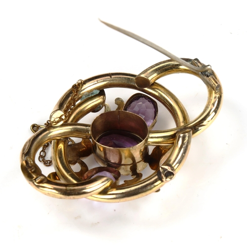 201 - A large Victorian amethyst knot brooch, unmarked yellow metal settings with floral engraved decorati... 