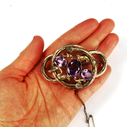 201 - A large Victorian amethyst knot brooch, unmarked yellow metal settings with floral engraved decorati... 