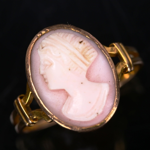 205 - An unmarked gold relief carved pink coral cameo ring, depicting female profile, setting height 16mm,... 